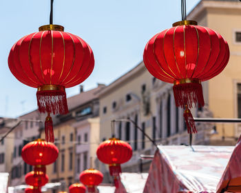 Red lanterns hanging against building in city