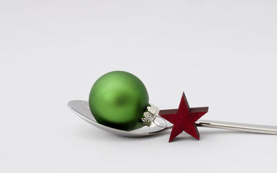 Close-up of christmas decorations over white background