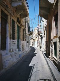 Narrow street leading towards buildings