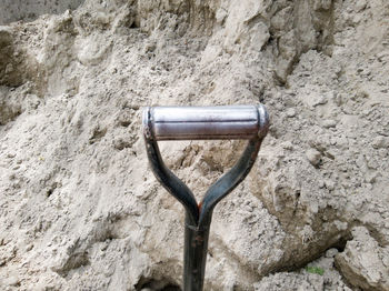 High angle view of old pipe on rock