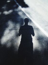 Shadow of man on street in city