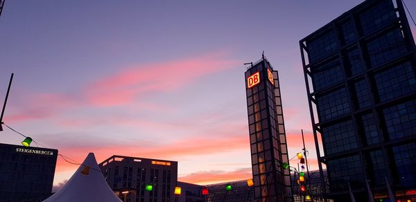 Low angle view of skyscraper against sky during sunset