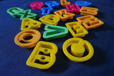 High angle view of multi colored alphabets on table