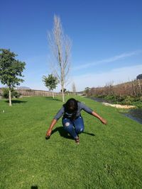 Boy on field against sky