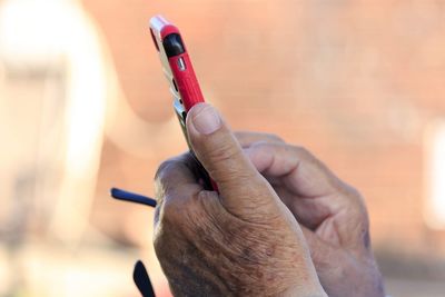 Close-up of man holding cigarette