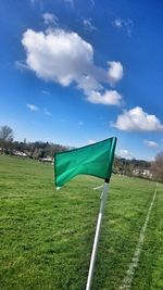 Scenic view of grassy field against cloudy sky