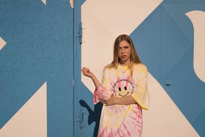 Woman standing against wall