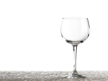 Close-up of wine glass against white background