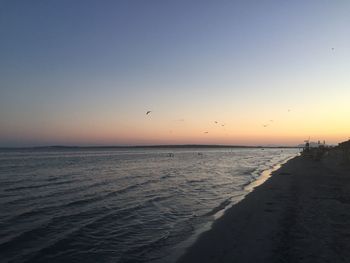 Scenic view of sea against clear sky during sunset