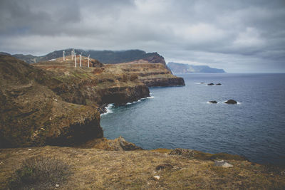 Scenic view of sea and mountains against sky