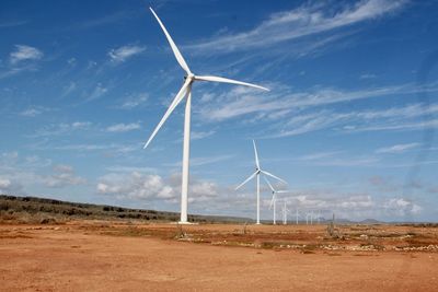 Windmill on field against sky