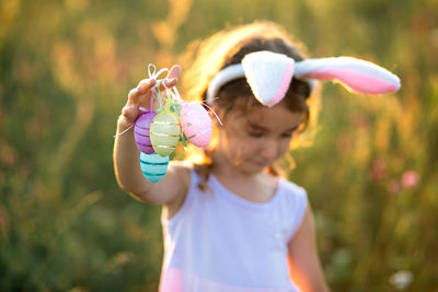 Portrait of cute girl blowing bubbles in park