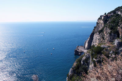 High angle view of sea and mountains against clear sky