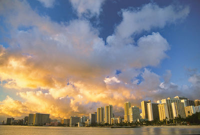 Cityscape against cloudy sky