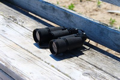 High angle view of binoculars on bench