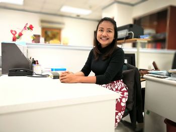 Portrait of young woman using phone