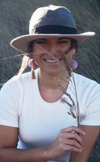 Portrait of smiling woman holding plants