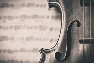 Cropped image of cello against sheet music