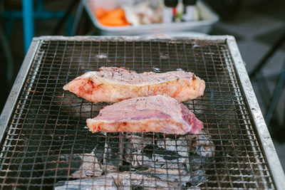 High angle view of meat on barbecue grill