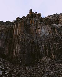 Low angle view of rock formations against sky