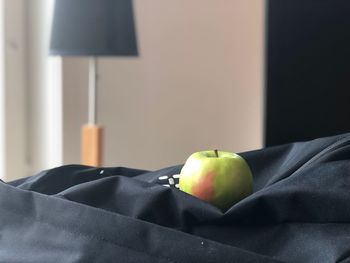 Close-up of apple on table at home