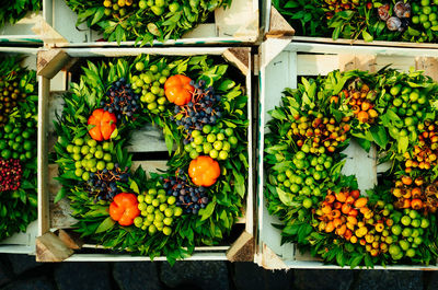Directly above view of various fruits in wooden crates at market stall