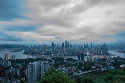 High angle view of cityscape against cloudy sky