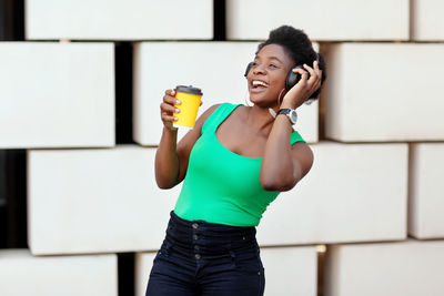 Full length of a beautiful young woman drinking water