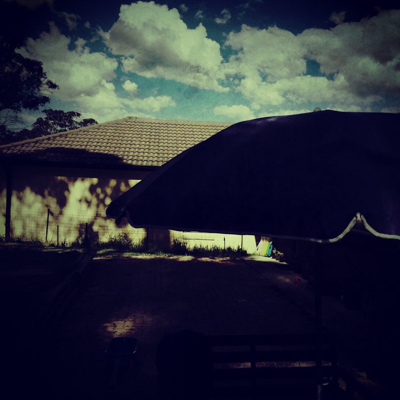 sky, cloud - sky, built structure, tree, architecture, house, field, building exterior, cloud, silhouette, cloudy, nature, no people, low angle view, dusk, outdoors, day, dark, growth, tranquility