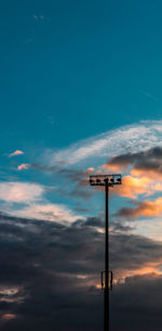Low angle view of street light against blue sky