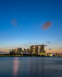 Illuminated buildings in city at waterfront