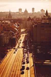 Cars on bridge by buildings