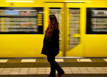 Blurred motion of man standing on railroad platform