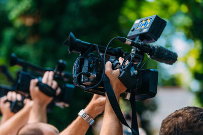 Cameras at a media conference outdoors.