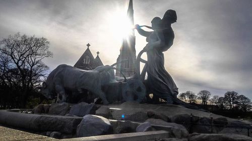 Low angle view of statue against sky