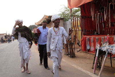 People walking on zebra crossing in city