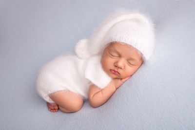 High angle view of cute baby boy sleeping on bed