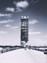 Tower bridge in city against sky