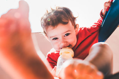 Boy holding bottle 