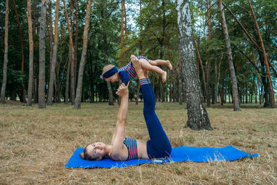 Mom and baby yoga outdoor classes. wellness, family yoga class, practicing mindfulness and