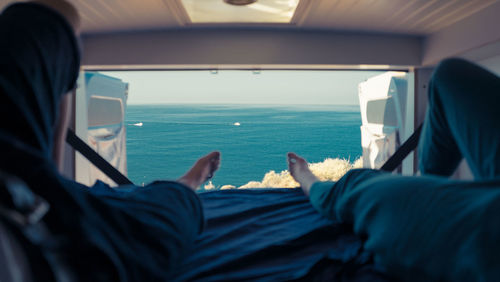 Low section of man relaxing in car
