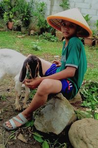 Boy wearing hat with lamb