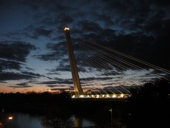 Low angle view of illuminated bridge against sky at night