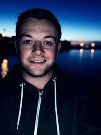 Portrait of smiling young man against sky