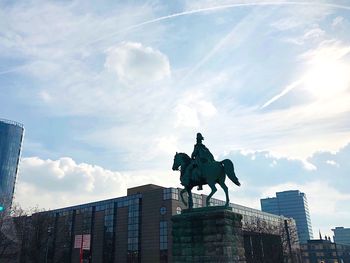 Low angle view of statue against sky in city