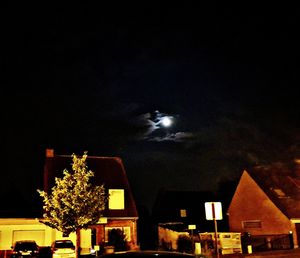 Low angle view of illuminated buildings against sky at night