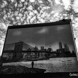 Buildings in city against cloudy sky