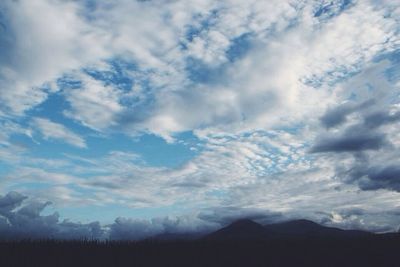 Scenic view of mountains against cloudy sky