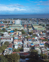 View of cityscape against blue sky