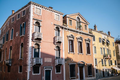 Low angle view of buildings against clear blue sky